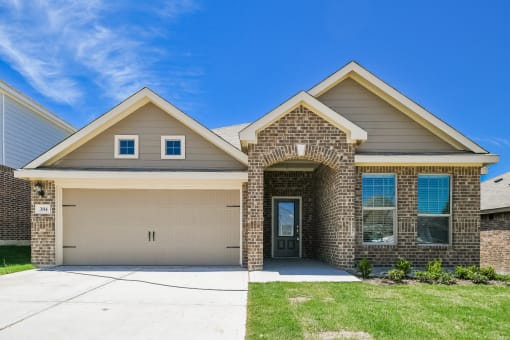 Homes Near Texas Christian University - Oak Ridge - An exterior shot of the front view of the brick houses at Oak Ridge, featuring a 2-car garage