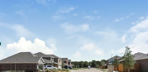 A row of houses with a car parked in front of them.