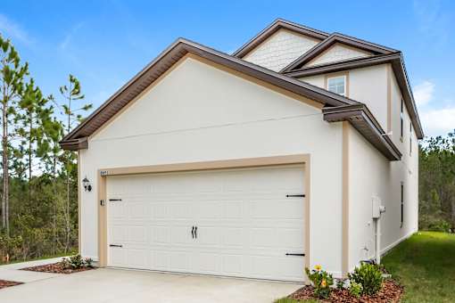 A modern house with a white garage door.
