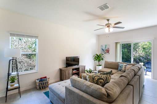 A living room with a large couch and a television.