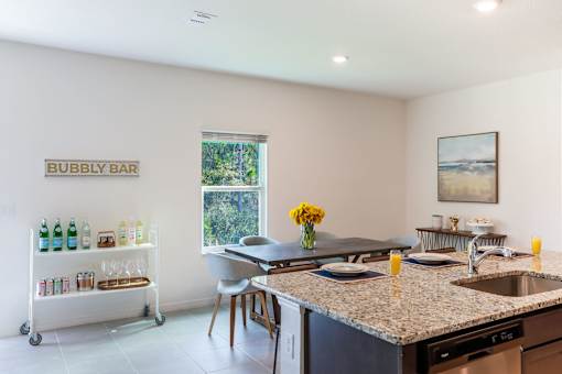 A kitchen with a bar cart and a window.