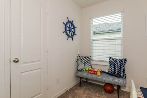 A small room with a bench and a ball on the floor.