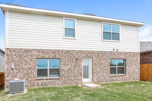 A house with a brick wall and a white siding wall.