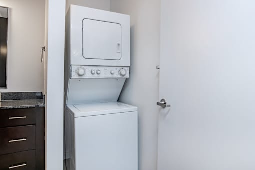 A white oven with a door open is in a kitchen.