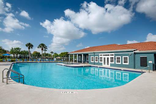 A large swimming pool with a building next to it.