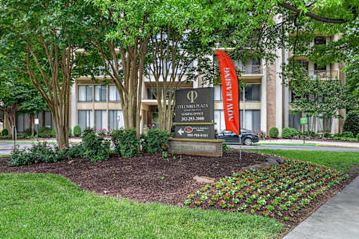 A sign in front of a building that says "Phi" on it.