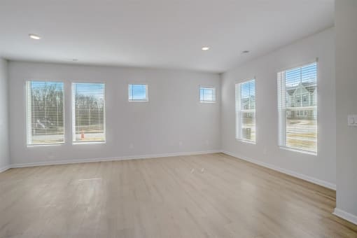 an empty living room with a hardwood floor