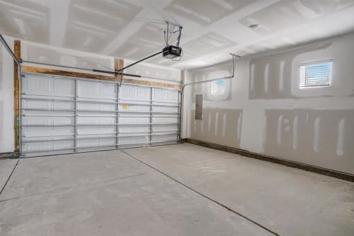 a large garage with white walls and a ceiling with a track light