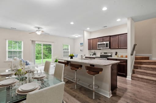 Omnia at Richmond Hill Townhomes in Georgia photo of a kitchen and dining area with a table and chairs and a counter top