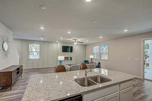 a kitchen with an island and a living room in the background
