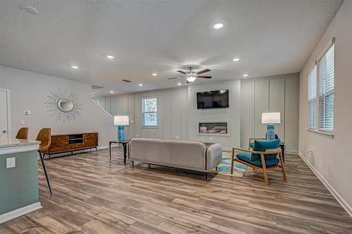a living room with a couch chairs and a fireplace