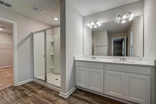 a bathroom with a large mirror and a walk in shower