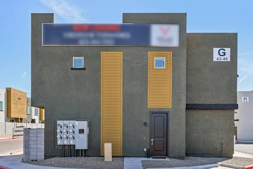 A building with a blue sign on the top and a number 43-49 on the right side.