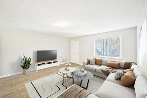Living area in three bedroom apartment at Amber Grove with modern design and large windows