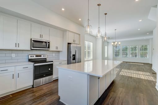 Luxury Three Bedroom Townhomes in Avondale Estates, GA – Henley Avondale – open kitchen with white cabinets and a large island