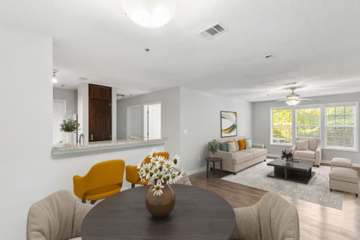 One K Apartments in Atlanta, GA photo of a living room and dining room with a table and chairs