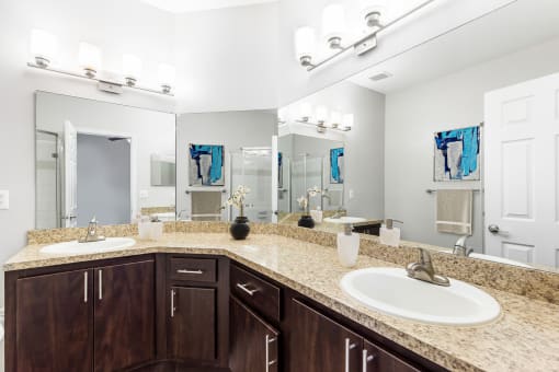 One K Apartments in Atlanta, GA photo of a bathroom with two sinks and a mirror