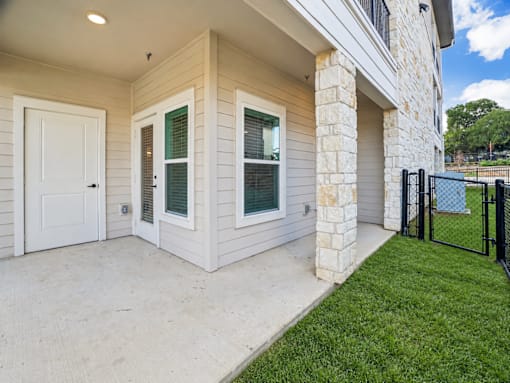 A house with a white door and a window with a black frame.