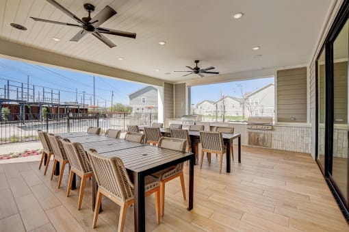 a large patio with a dining table and chairs