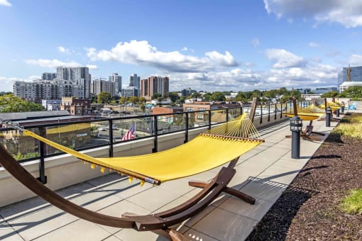 Yellow hammock on pool deck with views of skyline