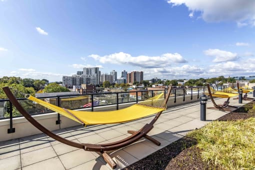 Rooftop outdoor space with hammocks and city views