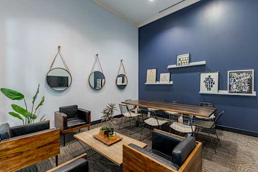 A room with a blue wall and a wooden table with chairs.