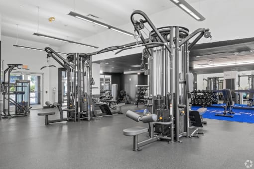 a gym with weights machines and other equipment in a hall