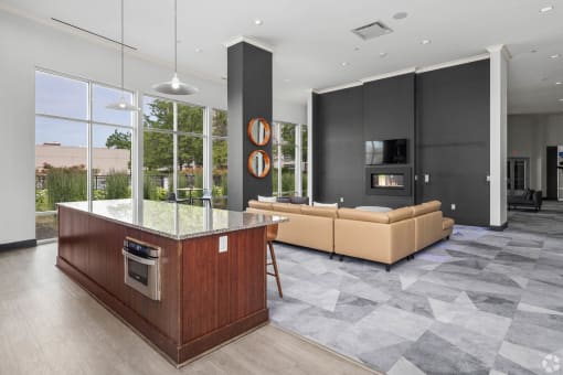 a large living room with a kitchen and a couch