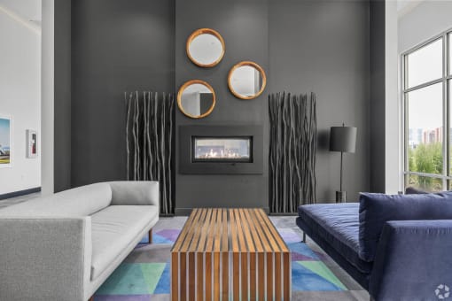 a living room with couches a coffee table and a fireplace