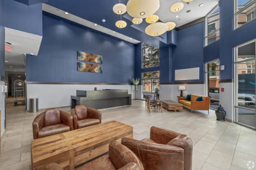 a lobby with couches and chairs and a table