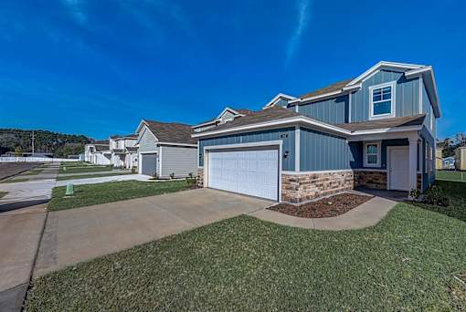 a home with a blue siding and a blue garage door