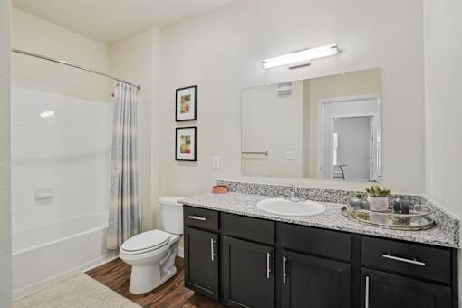 A bathroom with a white toilet, a white sink, and a white bathtub.