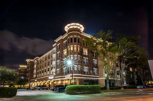 Apartments Near Memorial Park | Forum on San Felipe | Exterior Shot of the Apartment Complex, Featuring Well-Lit Lighting and a Curved Corner