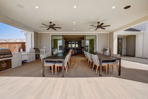 a large dining room and kitchen with a large table and chairs