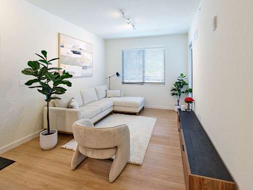Spacious open-concept living room with modern finishes, seamlessly connecting to the kitchen and dining areas at Gateway Luxury Apartments.
