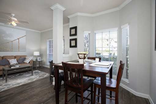 a dining room and living room with a table and chairs
