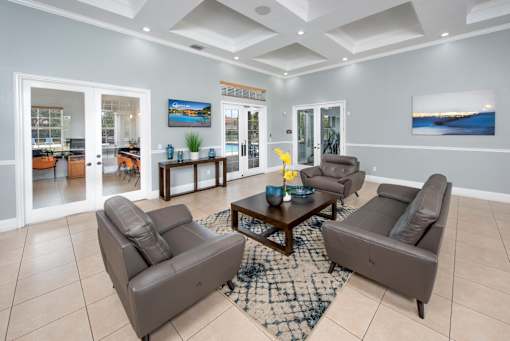 A living room with a brown leather couch and a coffee table.