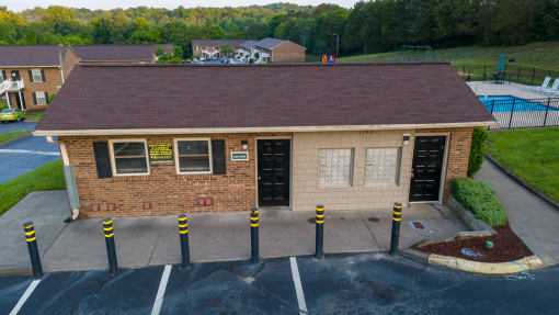 a view of the front of a brick building with a parking lot