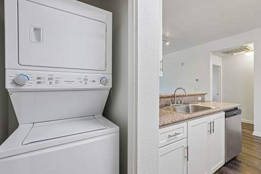 A white washing machine and dryer in a small kitchen.