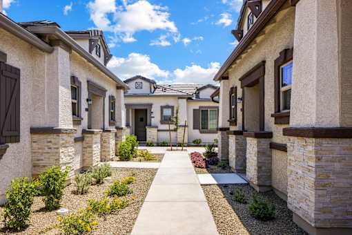 A row of houses with a pathway in the middle.