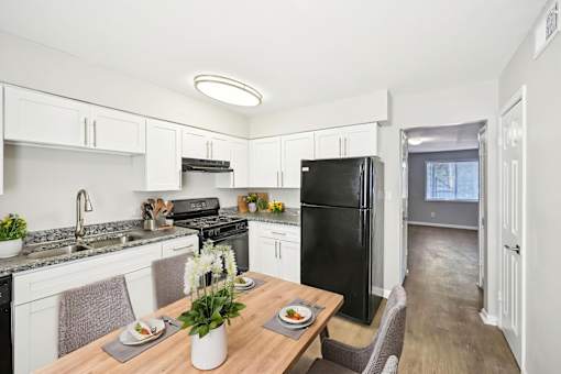 Updated kitchen in Marietta GA apartment with black appliances and granite-style counters
