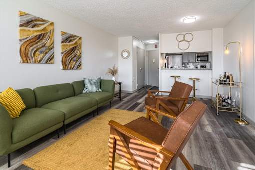 Open-concept apartment living area at Idlewild 45 Apartments in Memphis TN with modern seating and wood flooring