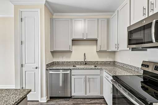 A modern Hawks Landing kitchen in Hickory NC featuring granite countertops and stainless-steel appliances