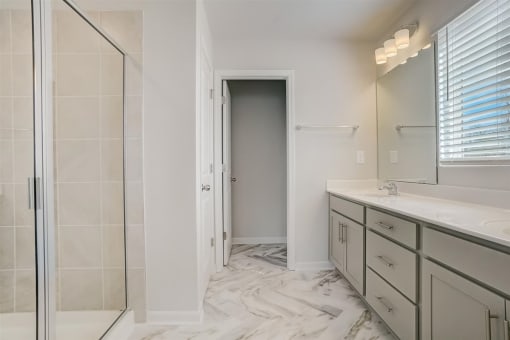 a bathroom with a large mirror and a walk in shower