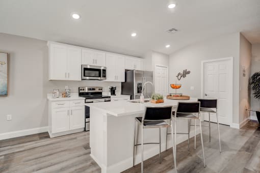 Lady Lake, FL Rentals – The Groves at Lake Ella -  luxury open kitchen with a large island with three stools