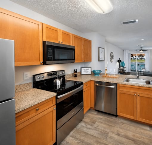 A kitchen with wooden cabinets and stainless steel appliances.