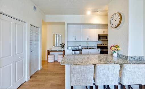 Modern kitchen at Gateway Luxury Apartments in Pompano Beach, featuring premium stainless-steel appliances, granite countertops, and a chef-inspired island.
