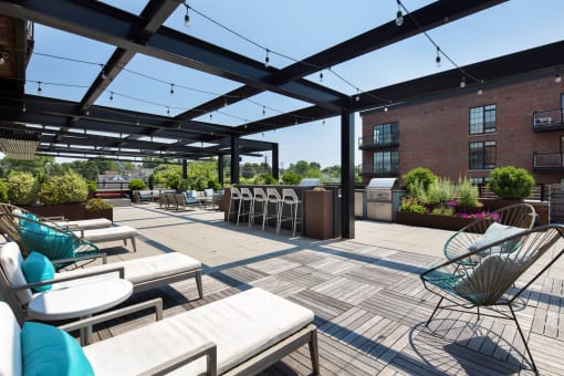 a large patio with tables and chairs and a bar