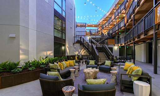 A patio with a staircase and a lot of seating.
