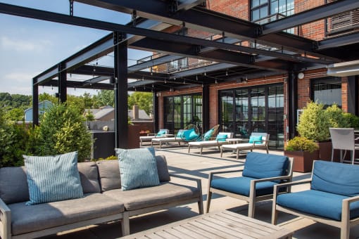 a patio with couches and chairs and a glass roof